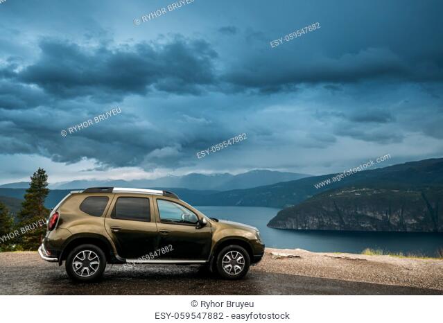Utvik, Sogn Og Fjordane County, Norway. Car Suv Parked Near Scenic Route Road In Norwegian Mountain Lake Landscape. Innvikfjord Is A Sub-fjord Of Nordfjord In...