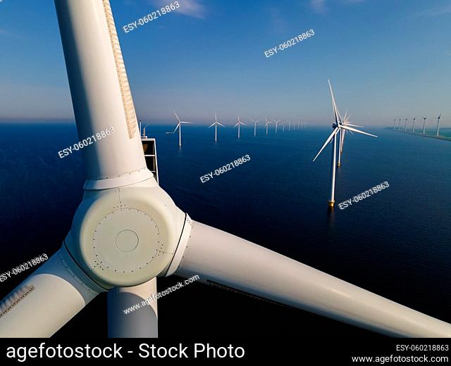 Wind turbine from an aerial view, Drone view at windpark a windmill farm in the lake IJsselmeer the biggest in the Netherlands, Sustainable development