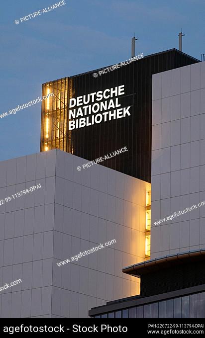 21 July 2022, Saxony, Leipzig: The new lettering ""Deutsche Nationalbibliothek"" (DNB) shines on a 55 meter high building of the former German Library