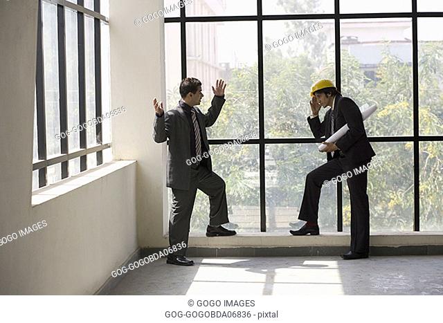 Businessmen talking in an unfinished room