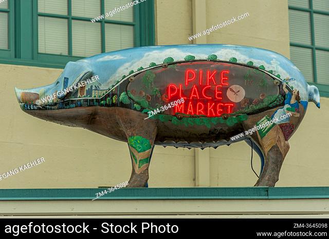 A pig statue with a neon Pike Place Market sign at the Pike Place Market in Seattle, Washington State, USA