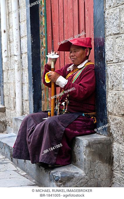 Female monk with a prayer wheel, Lhasa, Tibet, Asia