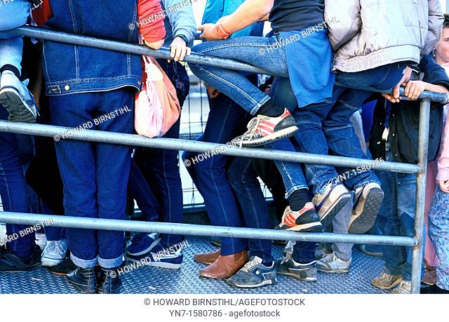 close up of a mass of teenage denim jeanery as they wait for who knows what