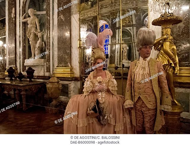 A couple in the Hall of Mirrors, courtship party (Fete galante) with participants wearing clothes from the Louis XIV period, Palace of Versailles, France