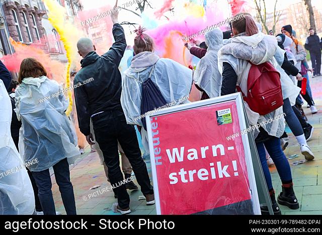 01 March 2023, Hamburg: Participants of a nationwide youth strike day of trainees and dual students in the public sector demonstrate with colorful Holi colors...