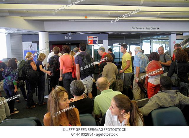 Florida, Miami, Miami International Airport, MIA, gate area, passengers, man, woman, boarding, crowded, line, queue