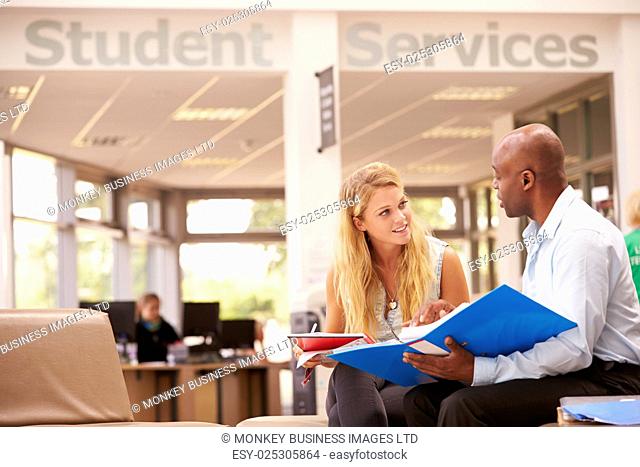 College Student Having Meeting With Tutor To Discuss Work