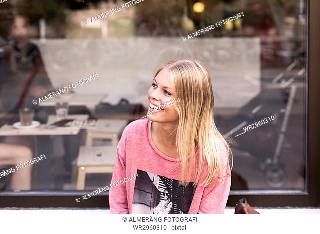 Smiling woman in front of cafe