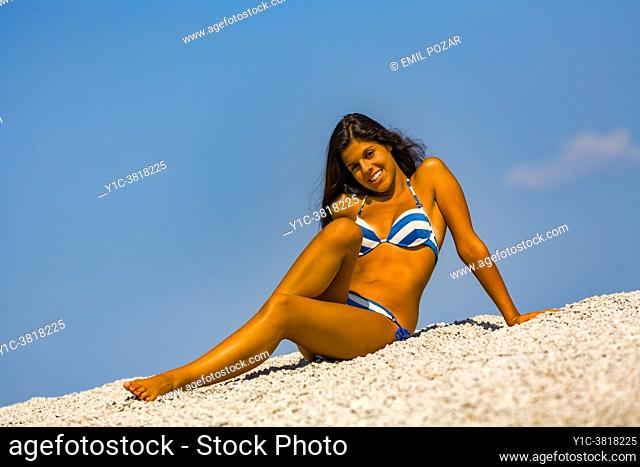 Teen girl in bikini against Blue sky