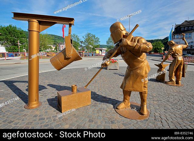 Golden sculptures with workers for steel production and steel processing with tools in the foundry in Alf, Moselle, Untermosel, Rhineland-Palatinate, Germany