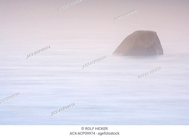 Boulder in the Pinware River mouth shrouded in fog at the Pinware River Provincial Park along the Labrador Coastal Drive, Viking Trail, Strait of Belle Isle