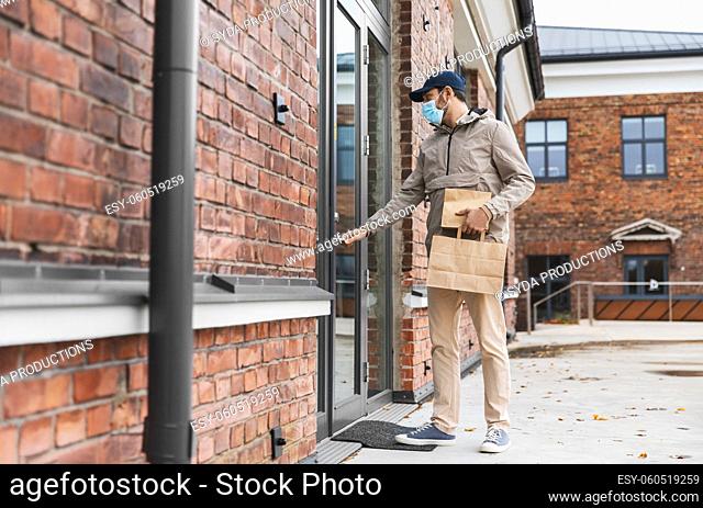 food delivery man in face mask with paper bags
