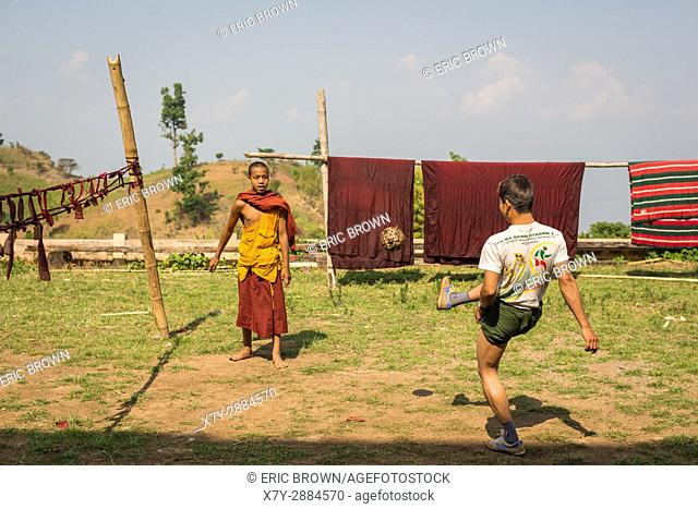 Young men kicking a wicker ball in a small village near Inle Lake, Myanmar