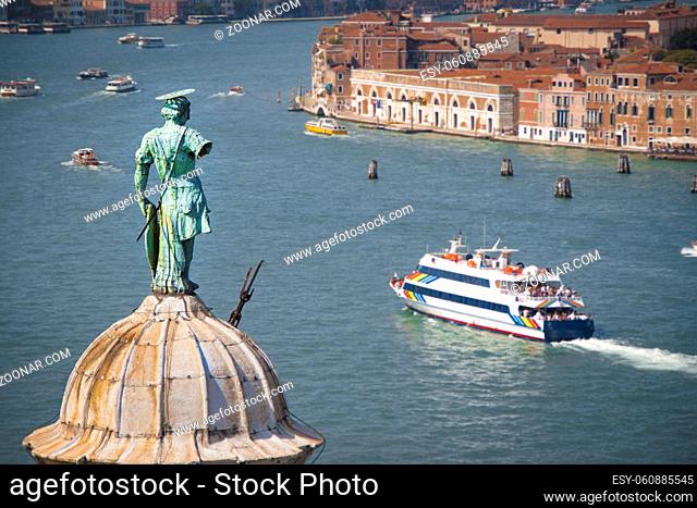 Aerial view of Venice lagoon and San Giorgio Maggiore dome with statue from the top of Campanile