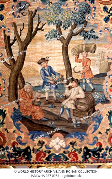 Giltwood needlework firescreen (18th Century) showing a harvest scene. ). Painting is on display at Kedleston Hall in Kedleston, Derbyshire