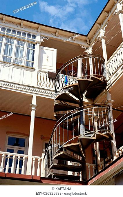 Traditional georgian architecture in Abanotubani historical part of Tbilisi - wooden balconies with nice carvings and spiral staircase , Georgia