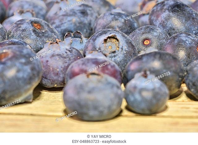 Blueberries on white wooden background. Bilberries, blueberries, huckleberries, whortleberries Close-up