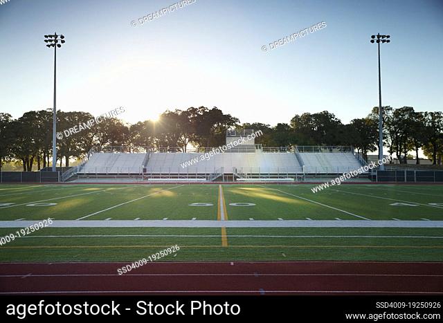 Field level view of a high school track and football field in Texas at sunrise