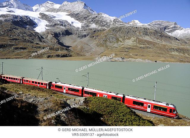 Swiss Alps: Unesco World Heritage Train trip in the Upper Engadin at glacier lake "Lago Bianco " at Bernina Pass