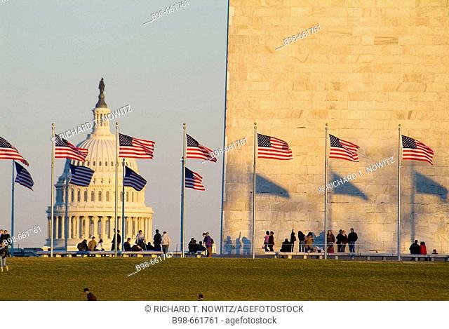 United States, Washington, District of Columbia, US Capitol Building with flags at the Washington Monument and tourists
