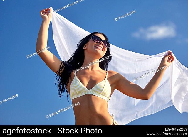 woman in bikini swimsuit with cover-up over sky