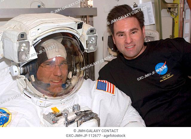 Astronauts Steve Bowen (left) and Greg Chamitoff, both STS-126 mission specialists, take a moment for a photo during preparations for the mission's first...