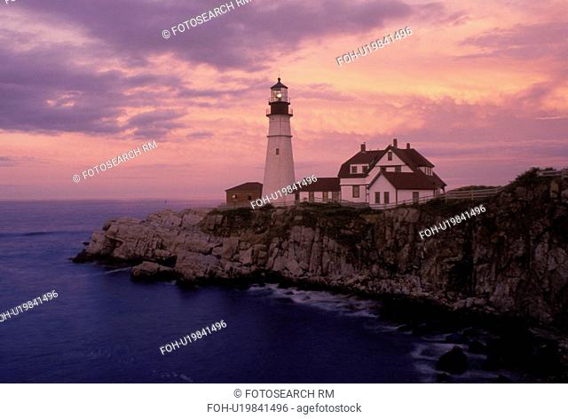 Cape Elizabeth, ME, Maine, Portland Headlight along the rocky coastline of the Atlantic Ocean at sunset