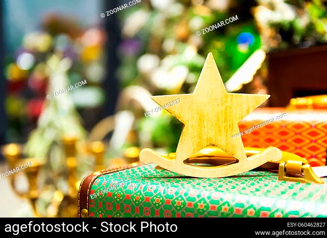 Christmas Fir Tree Toys Old wooden star It stands on an retro suitcase Burning Candles, Boxes, Balls, Pine Cones, Walnuts