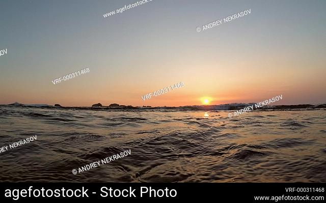 Sea wave is slowly floating towards the camera at sunset - Split level, Indian Ocean, Hikkaduwa; Sri Lanka