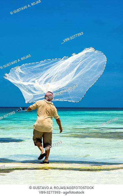 A Fisherman casts his fishing net at los roques venezuela