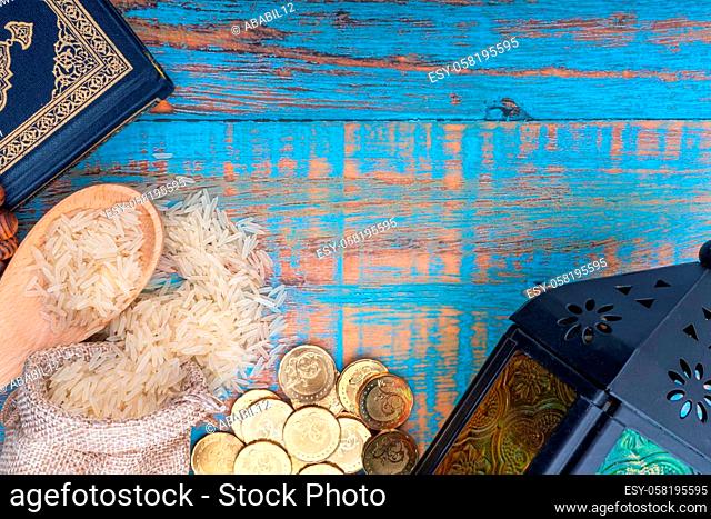 Holy Quran, Coins, Rosary and Rice. Zakat concept. Zakat is a form of alm-giving as a religious obligation