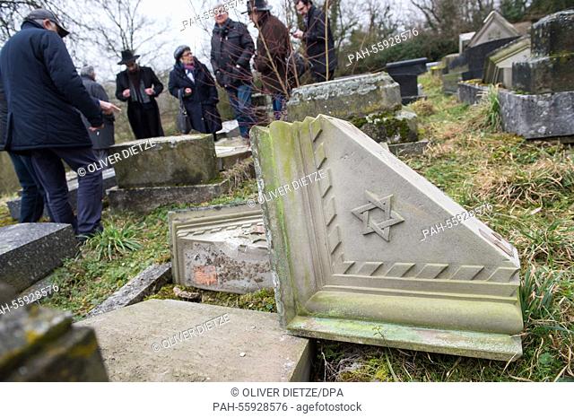 After a commemoration at a Jewish cemetery people are allowed to return to the graves in Sarre-Union, France, 17 February 2015