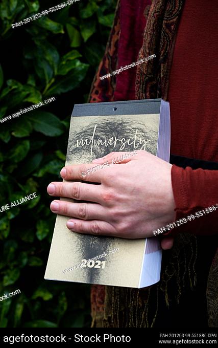 19 November 2020, Baden-Wuerttemberg, Freiburg: A member of the Freiburg collective Vulvaversity is holding one of her calendars