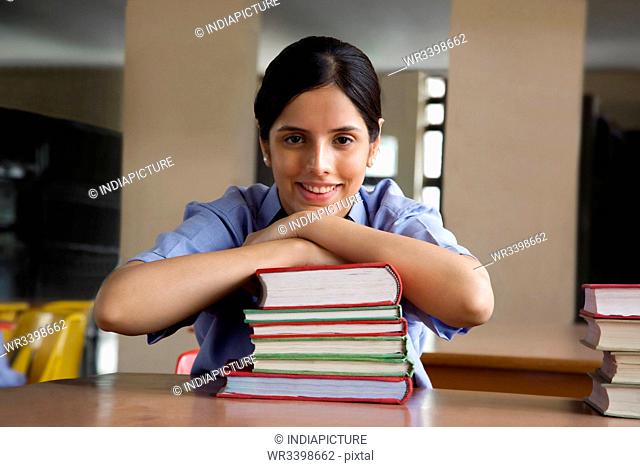 Portrait of a girl leaning on some books