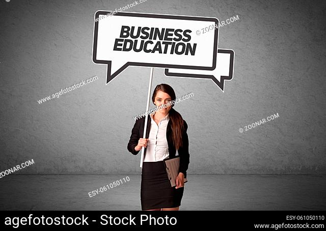 Young business person in casual holding road sign with BUSINESS EDUCATION inscription, new business idea concept