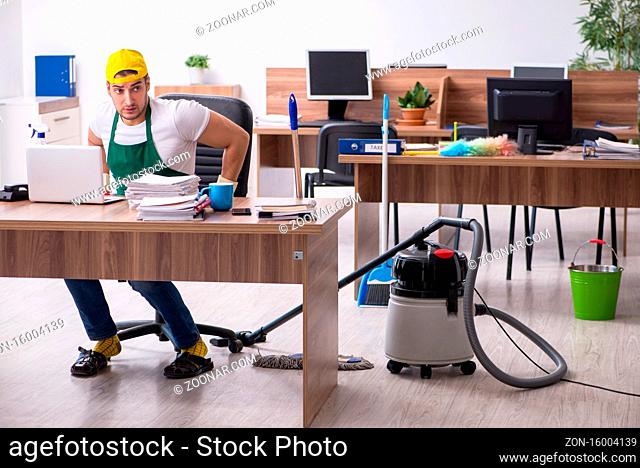 Young contractor cleaning the office