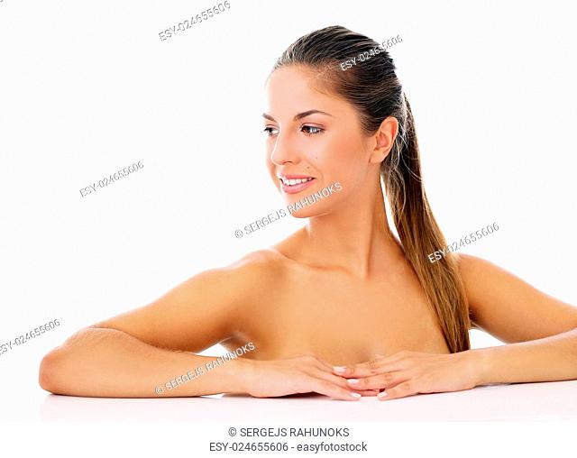 Portrait of a beautiful woman who is posing happily and tenderly over a white background