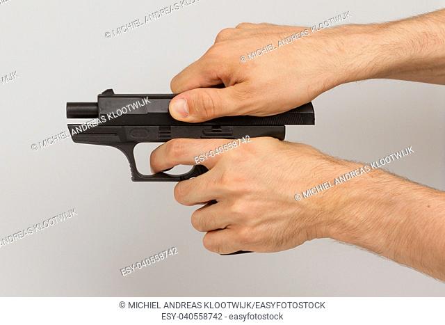 Pistol in hand, isolated on white background
