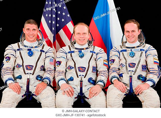 Russian cosmonaut Oleg Kotov (center), Expedition 37 flight engineer and Expedition 38 commander; along with NASA astronaut Michael Hopkins (left) and Russian...