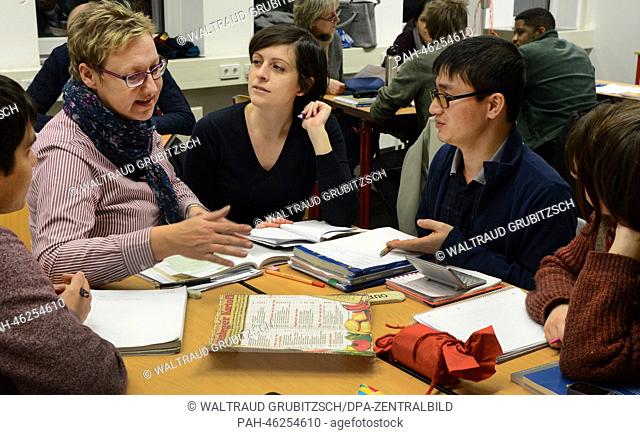 Albane Roche from France (R-L), Nhu Huynh from Vietnam, Gaia Manco from Italy and Halil Coban from Turkey practice every-day situations in German with their...