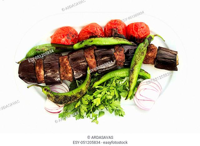 Eggplant kebab in Turkish Patlican Kebap, on a white background and white plate