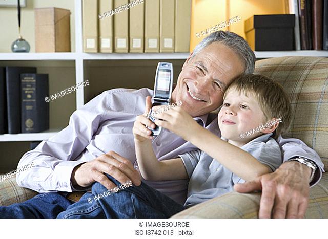 Boy and grandfather with camera phone