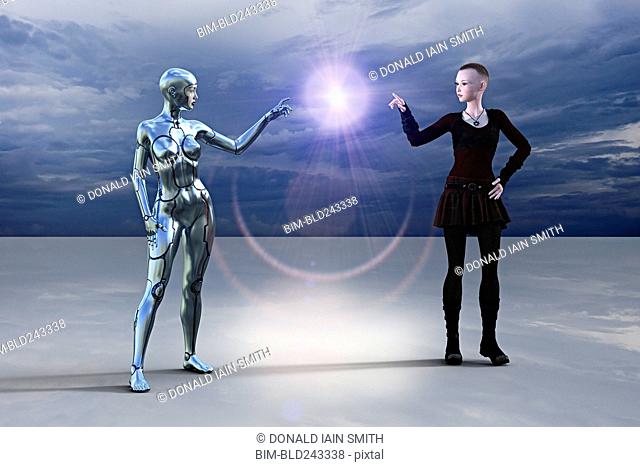 Silver female cyborg and woman pointing at glowing light