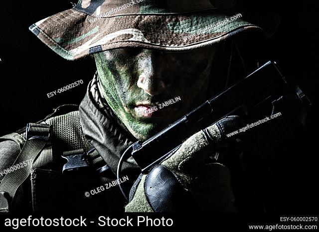 Jagdkommando soldier Austrian special forces with pistol on dark background
