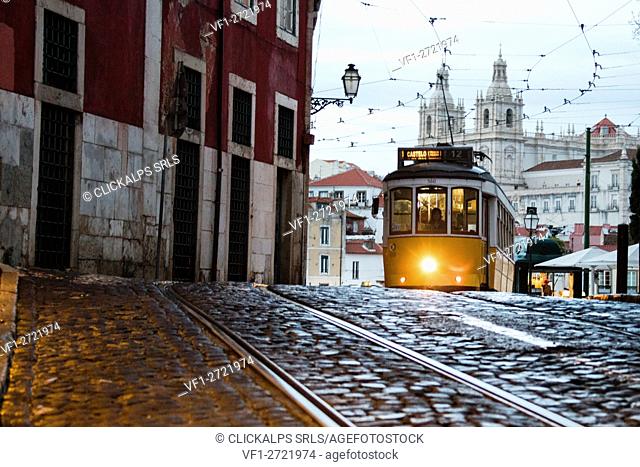 Romantic atmosphere in the old streets of Alfama with the castle in the background and tram number 28 Lisbon Portugal Europe