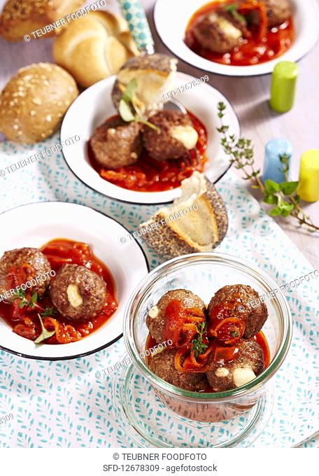 Roasted meatballs with an onion sauce and a mozzarella filling