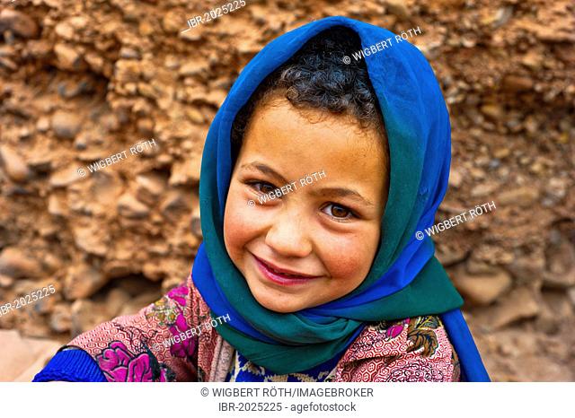 Portrait of a smiling young girl wearing a blue head scarf, nomadic cave-dweller, Berber, Dades Valley, High Atlas Mountains, southern Morocco, Morocco, Africa