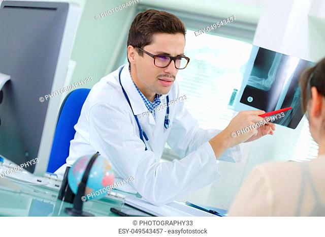 doctor pointing at x-ray in medical office
