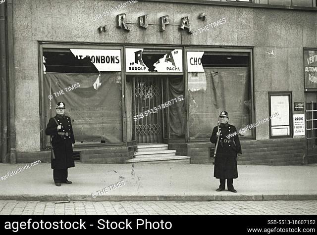 Czech Crisis: Scene in Sudenenland.Armed police guarding a shop in Eger during the disturbances which took place this week-end. October 13, 1938
