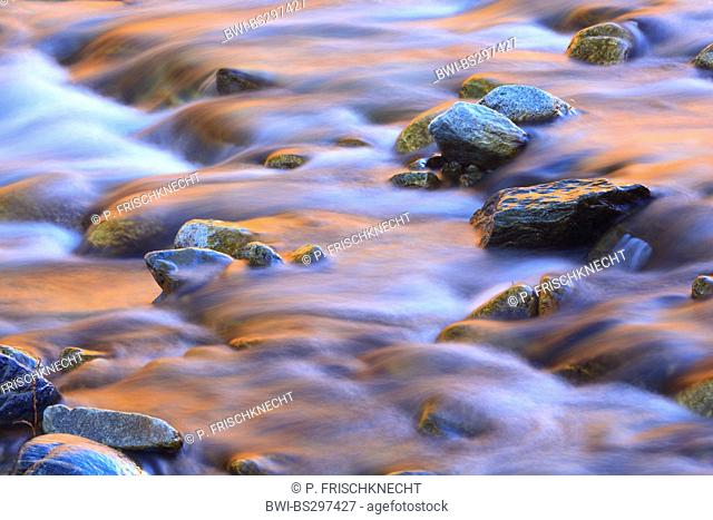stones and reflexions of the afterglow in the riverbed of the Lonza in the Loetschental, Switzerland, Valais